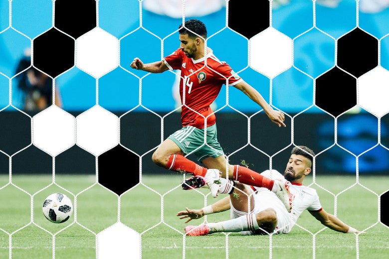 Grass flies as Manuel da Costa of Morocco is fouled by Ramin Rezaeian of Iran.